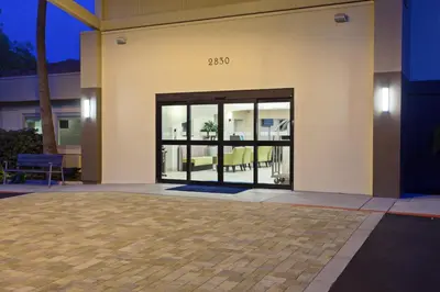 a house with glass doors with a patio at Holiday Inn Express San Bernardino Colton by IHG in Colton