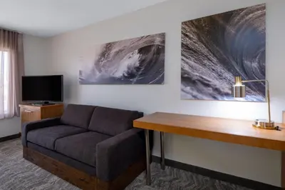 a living room with a couch and a desk at SpringHill Suites Pasadena Arcadia in Arcadia