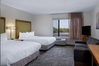 a hotel room with two beds and a television at SpringHill Suites Pasadena Arcadia in Arcadia