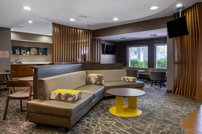 a living room with a couch and a table at SpringHill Suites Pasadena Arcadia in Arcadia