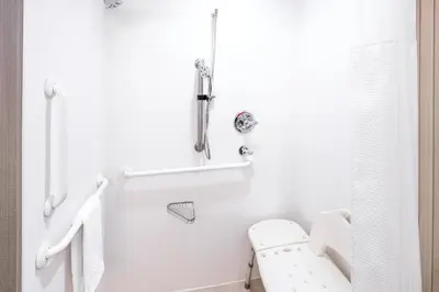 a white bathroom with a toilet and a sink at Courtyard by Marriott Ontario Rancho Cucamonga in Rancho Cucamonga