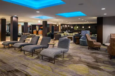 a lobby with chairs and a waiting room at Courtyard by Marriott Victorville Hesperia in Hesperia