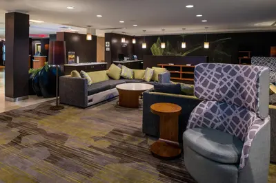 a lobby with couches and chairs and a table at Courtyard by Marriott Victorville Hesperia in Hesperia