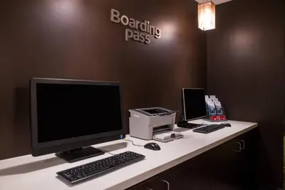 a desk with a computer and a monitor and keyboard at Courtyard by Marriott Victorville Hesperia in Hesperia