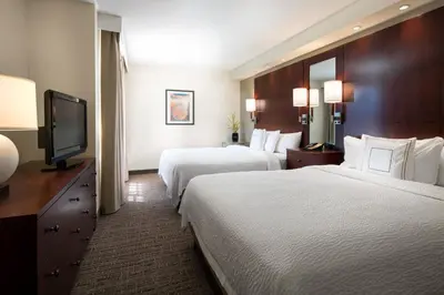 a hotel room with two beds and a flat screen tv at Residence Inn by Marriott Camarillo in Camarillo