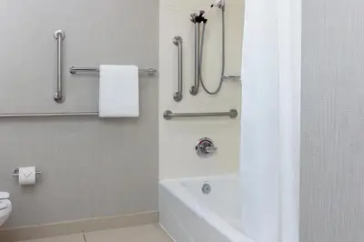 a bathroom with a shower and a tub and a toilet at Residence Inn by Marriott Corona Riverside in Corona