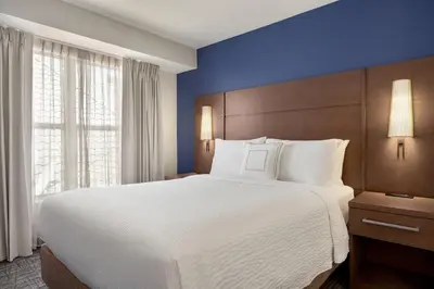 a hotel room with a large bed and a window at Residence Inn by Marriott Palmdale Lancaster in Palmdale