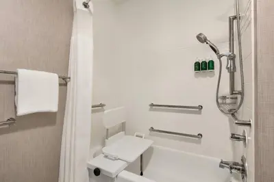a white bathroom with a shower and a toilet at Residence Inn by Marriott Palmdale Lancaster in Palmdale