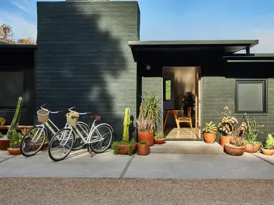 two bikes parked in front of a house with plants at Hotel June Malibu in Malibu