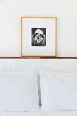 a shelf with a picture of a man wearing a hat at Hotel June Malibu in Malibu