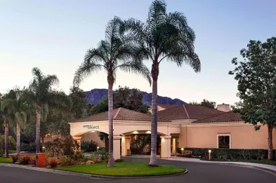 a house with two palm trees in the driveway at Sonesta Select Camarillo in Camarillo