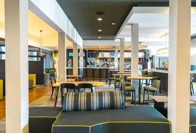 a lobby with a couch and tables and chairs at Sonesta Select Camarillo in Camarillo