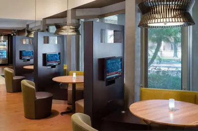 a restaurant with two tables and chairs and televisions at Sonesta Select Camarillo in Camarillo