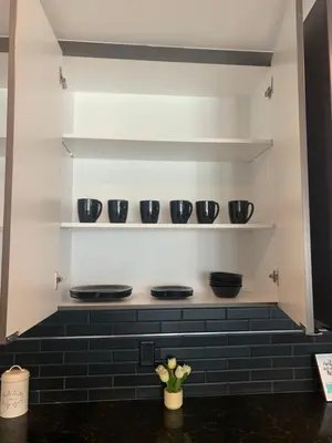 a kitchen with black bowls and plates on shelves at Top Floor 3 Bed 3 Bath Penthouse Living In Luxury in Los Angeles