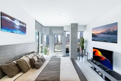 a living room with a couch and a tv at Top Floor 3 Bed 3 Bath Penthouse Living In Luxury in Los Angeles