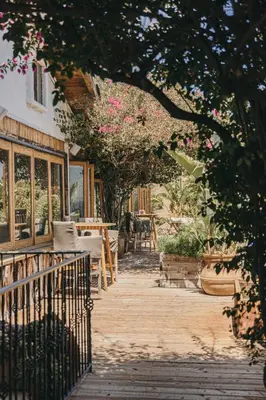 a porch of a house with a table and chairs at CALAMIGOS RANCH Resort & Spa in Malibu
