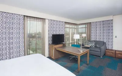 a hotel room with a bed and a desk and a couch at Hampton Inn & Suites LAX El Segundo in El Segundo
