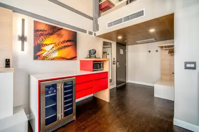 a kitchen with red cabinets and a painting on the wall at Century Park Hotel LA in Los Angeles