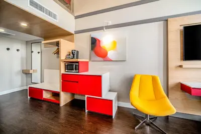a room with a desk and a yellow chair at Century Park Hotel LA in Los Angeles