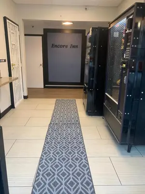 a store hallway with a black and white floor at Encore Inn Inglewood in Inglewood