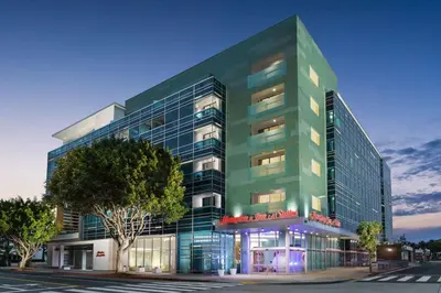 a tall green building with a street in front of it at Hampton Inn & Suites Santa Monica in Los Angeles