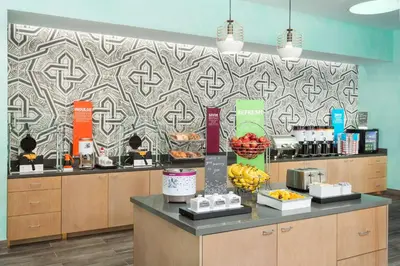 a restaurant with a counter with fruit on it at Hampton Inn & Suites Santa Monica in Los Angeles