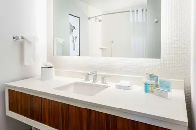 a bathroom with a white sink and a mirror at Hampton Inn & Suites Santa Monica in Los Angeles