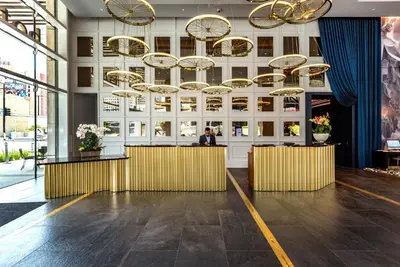 a lobby with a bar and chandeliers at Hotel Indigo Los Angeles Downtown by IHG in Los Angeles