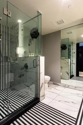 a bathroom with a glass shower and a toilet at Hotel Indigo Los Angeles Downtown by IHG in Los Angeles