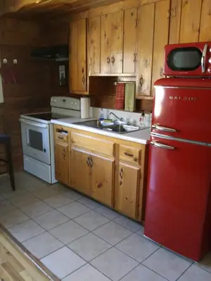 a kitchen with a red refrigerator and a sink at Kern Riverfront Lodge in Kernville