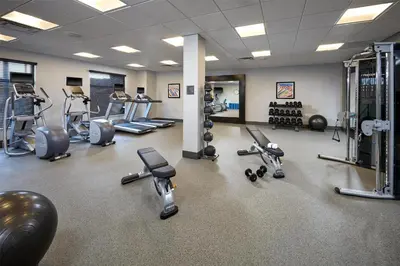 a gym with several treadmills and machines in it at Homewood Suites By Hilton Los Angeles Redondo Beach in Redondo Beach