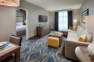 a hotel room with a couch and a bed at Homewood Suites By Hilton Los Angeles Redondo Beach in Redondo Beach