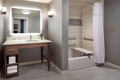a bathroom with a sink and a tub and a shower at Homewood Suites By Hilton Los Angeles Redondo Beach in Redondo Beach