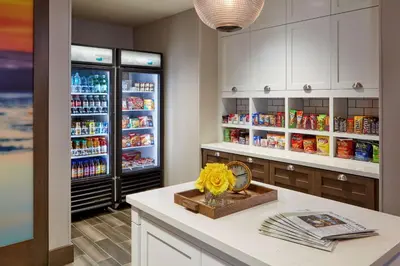 a kitchen with an open refrigerator with drinks at Homewood Suites By Hilton Los Angeles Redondo Beach in Redondo Beach