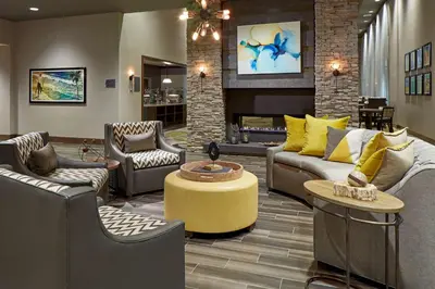 a living room with couches and a fireplace at Homewood Suites By Hilton Los Angeles Redondo Beach in Redondo Beach