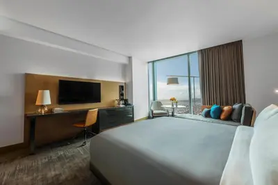 a hotel room with a bed and a desk and a television at InterContinental - Los Angeles Downtown by IHG in Los Angeles