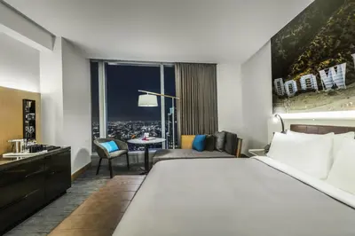 a hotel room with a large bed and a table at InterContinental - Los Angeles Downtown by IHG in Los Angeles