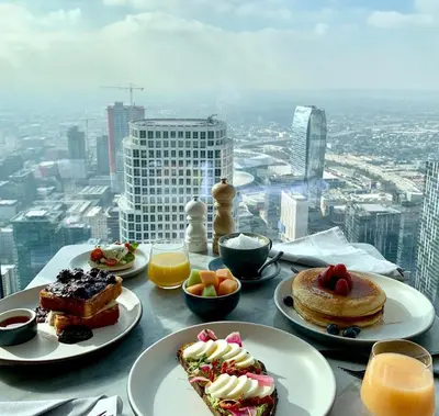 a table with plates of food on top of a building at InterContinental - Los Angeles Downtown by IHG in Los Angeles