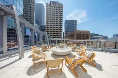 a balcony with chairs and a table on a building at InterContinental - Los Angeles Downtown by IHG in Los Angeles