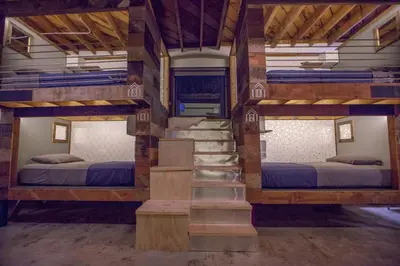 a room with two bunk beds and a staircase at PodShare East Hollywood in Los Angeles
