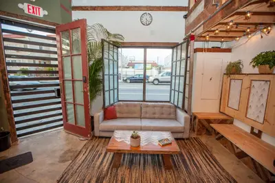 a living room with a couch and a table at PodShare East Hollywood in Los Angeles