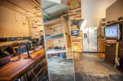 an office with a desk and a mirror in a room at PodShare Hollywood in Los Angeles
