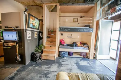 a room with a bunk bed and a tv at PodShare Hollywood in Los Angeles