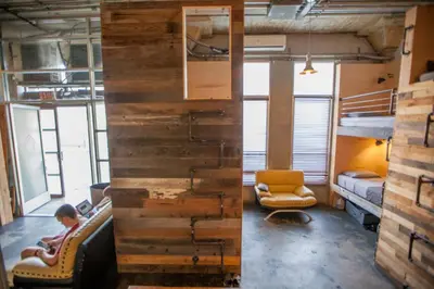 a room with a wall of reclaimed wood at PodShare Hollywood in Los Angeles
