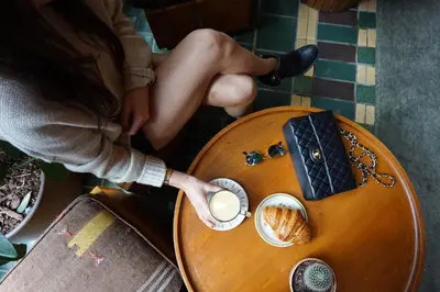 a woman sitting at a table with a cup of coffee at Freehand Los Angeles in Los Angeles