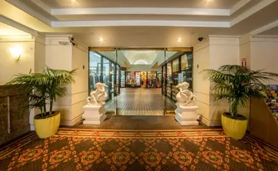 a hallway with two statues in a building at Olyver Hotel in Los Angeles