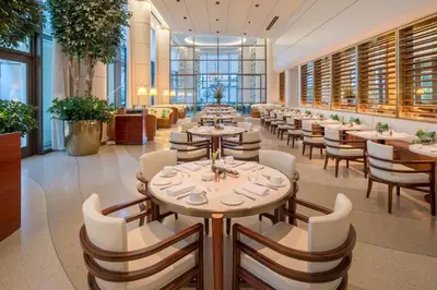 a row of tables and chairs in a restaurant at Waldorf Astoria Beverly Hills in Los Angeles