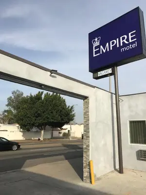 a sign for an entrance to an emprise motel at Empire Inn in Los Angeles
