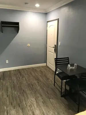 a dining room with a table and a white door at Empire Inn in Los Angeles