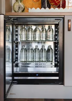 a microwave oven with glass bottles in it at Le Petit Pali Brentwood in Los Angeles